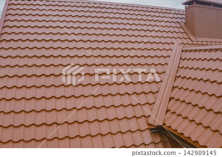 Corrugated metal roof and metal roofing. Modern roof made of metal. Corrugated metal roof and metal roofing. Modern roof made of metal. 142989145