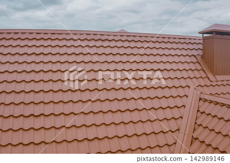 Corrugated metal roof and metal roofing. Modern roof made of metal. Corrugated metal roof and metal roofing. Modern roof made of metal. 142989146