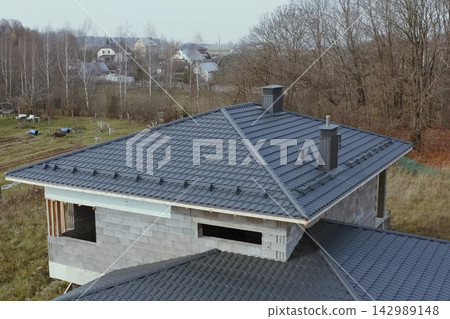 Corrugated metal roof and metal roofing. Modern roof made of metal. Corrugated metal roof and metal roofing. Modern roof made of metal. 142989148