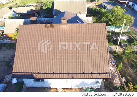Corrugated metal roof and metal roofing. Modern roof made of metal. Corrugated metal roof and metal roofing. Modern roof made of metal. 142989169