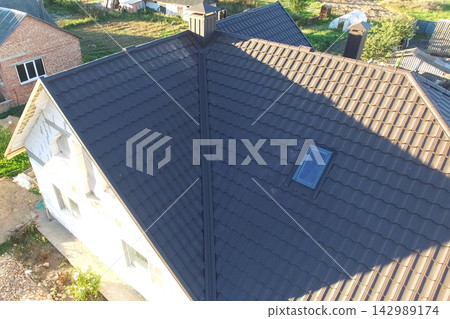 Corrugated metal roof and metal roofing. Modern roof made of metal. 142989174
