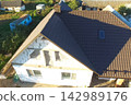 Corrugated metal roof and metal roofing. Modern roof made of metal. 142989176