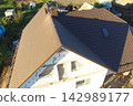 Corrugated metal roof and metal roofing. Modern roof made of metal. 142989177