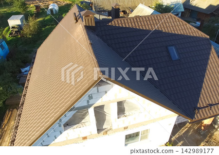 Corrugated metal roof and metal roofing. Modern roof made of metal. 142989177
