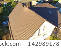 Corrugated metal roof and metal roofing. Modern roof made of metal. 142989178