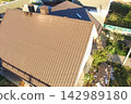 Corrugated metal roof and metal roofing. Modern roof made of metal. 142989180