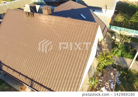 Corrugated metal roof and metal roofing. Modern roof made of metal. Corrugated metal roof and metal roofing. Modern roof made of metal. 142989180