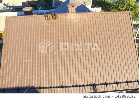 Corrugated metal roof and metal roofing. Modern roof made of metal. Corrugated metal roof and metal roofing. Modern roof made of metal. 142989182