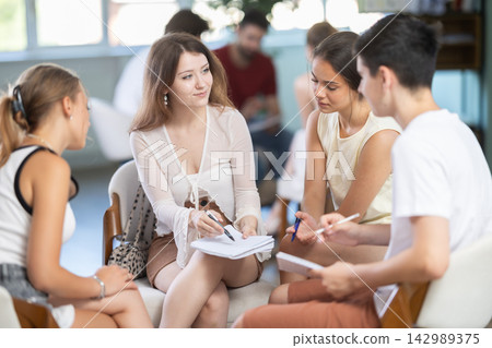 Students have divided into two teams and are discussing tactics of debate or competition Students have divided into two teams and are discussing tactics of debate or competition 142989375