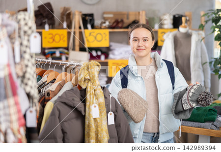 Teenage girl choosing a hat in the store Teenage girl choosing a hat in the store 142989394