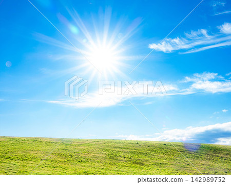 A simple image of a landscape with a blue sky, a grassland, and the bright sunlight. A simple image of a landscape with a blue sky, a grassland, and the bright sunlight. 142989752