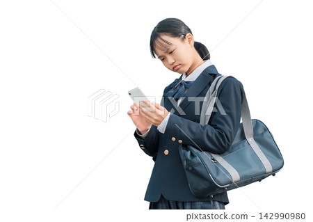 Female junior high school students and high school students in uniforms who are troubled, worried, or thinking while looking at their smartphones Female junior high school students and high school students in uniforms who are troubled, worried, or thinking while looking at their smartphones 142990980