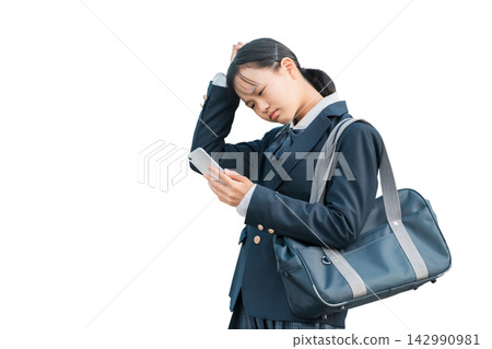 Female junior high school students and high school students in uniforms who are troubled, worried, or thinking while looking at their smartphones Female junior high school students and high school students in uniforms who are troubled, worried, or thinking while looking at their smartphones 142990981