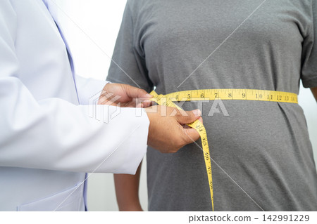 Asian woman with fat belly big size overweight and obesity with measure tape. Asian woman with fat belly big size overweight and obesity with measure tape. 142991229
