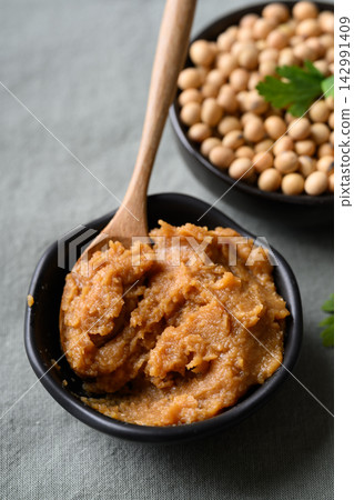Miso paste in a black bowl with wooden spoon Miso paste in a black bowl with wooden spoon 142991409
