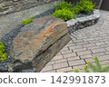 Curved Garden Path Through Landscaped Yard 142991873