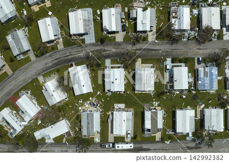 Hurricane destroyed suburban houses roofs in Florida mobile home residential area. Consequences of natural disaster Hurricane destroyed suburban houses roofs in Florida mobile home residential area. Consequences of natural disaster 142992382