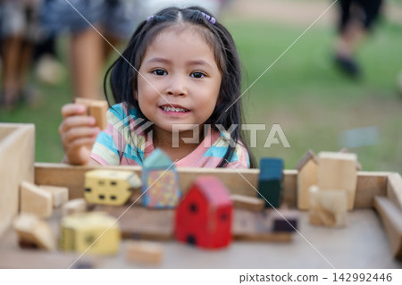 preschool child girl playing with wooden toy block at outdoor preschool child girl playing with wooden toy block at outdoor 142992446
