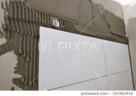 Wall ceramic tiles installation on mortar glue. Wall ceramic tiles installation on mortar glue. 142992918