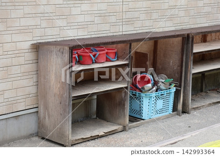 A scene of a shelf containing buckets and other sand play equipment. A scene of a shelf containing buckets and other sand play equipment. 142993364