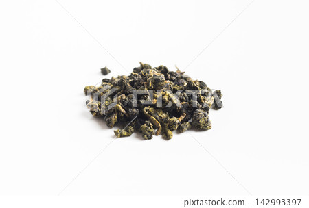 Close up of dried rolled taiwan oolong tea leaves pile isolated on white background with copy space Close up of dried rolled taiwan oolong tea leaves pile isolated on white background with copy space 142993397