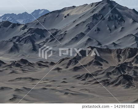 Carved desert dunes and rocky ridges Carved desert dunes and rocky ridges 142993882