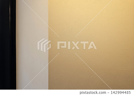 Modern architectural wall with gold textured surface and black frame detail. Modern architectural wall with gold textured surface and black frame detail. 142994485