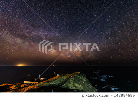 繁星點點的夜空照亮了太平洋的礁石,銀河中繁星閃爍,璀璨奪目。北海道惠裡茂町。 繁星點點的夜空照亮了太平洋的礁石,銀河中繁星閃爍,璀璨奪目。北海道惠裡茂町。 142994699