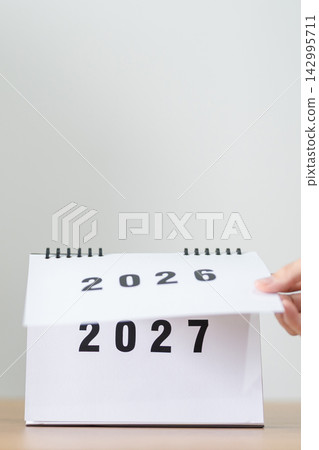 2026 to 2027 New Year Concept. Hand Turning Calendar Page Representing New Beginning, Year Transition, Future Planning, Change, Growth, Goal Setting and Fresh Start 2026 to 2027 New Year Concept. Hand Turning Calendar Page Representing New Beginning, Year Transition, Future Planning, Change, Growth, Goal Setting and Fresh Start 142995711