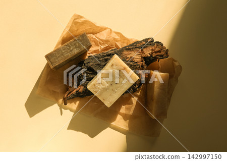 Natural soaps placed on brown craft paper with wood pieces Natural soaps placed on brown craft paper with wood pieces 142997150