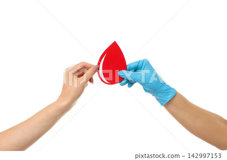 Gloved hand shows red drop for blood donation, isolated on white, PNG 142997153