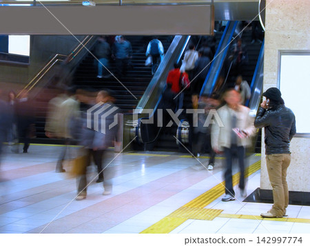 Blurred Commuters in Busy Subway Station with Escalators 142997774