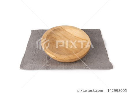 Empty wood bowl isolated, light plate on grey tablecloth, rustic dish mockup on cloth napkin Empty wood bowl isolated, light plate on grey tablecloth, rustic dish mockup on cloth napkin 142998005