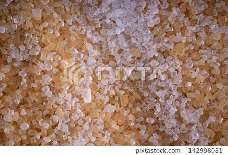 Brown cane sugar pile textured background top view Brown cane sugar pile textured background top view 142998081
