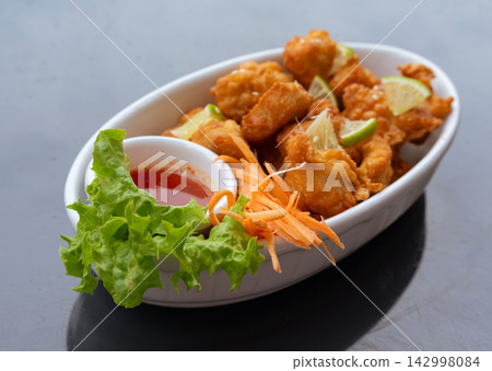 Crispy chicken popcorn with tomato sauce closeup Crispy chicken popcorn with tomato sauce closeup 142998084