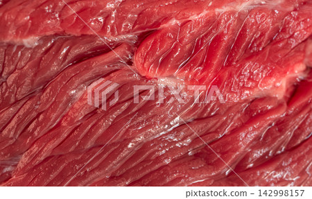 Raw beef steak macro pattern, red meat slice closeup Raw beef steak macro pattern, red meat slice closeup 142998157