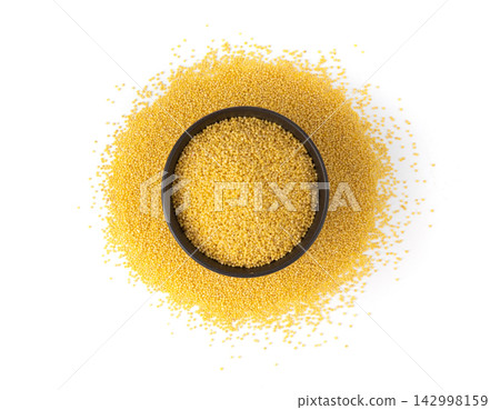 Raw millet grains pile isolated. Little yellow cereal, natural foxtail small seeds Raw millet grains pile isolated. Little yellow cereal, natural foxtail small seeds 142998159
