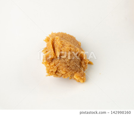 Miso paste isolated. Japanese shiro miso seasoning sauce, fermented soybean spread, brown soy cream Miso paste isolated. Japanese shiro miso seasoning sauce, fermented soybean spread, brown soy cream 142998160