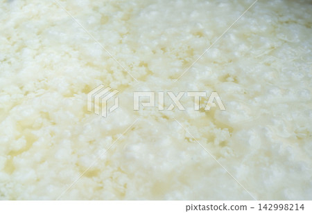 Cottage cheese making, curd in whey texture closeup Cottage cheese making, curd in whey texture closeup 142998214