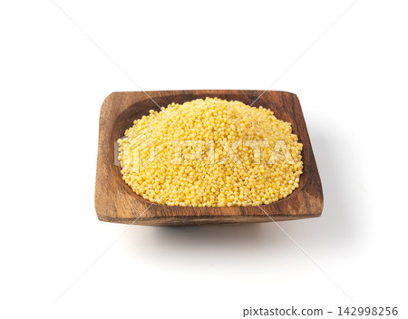 Raw millet grains pile isolated. Little yellow cereal, natural foxtail small seeds Raw millet grains pile isolated. Little yellow cereal, natural foxtail small seeds 142998256