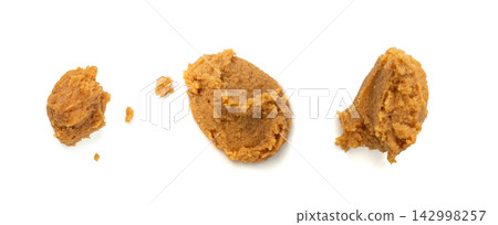 Miso paste isolated. Japanese shiro miso seasoning sauce, fermented soybean spread, brown soy cream Miso paste isolated. Japanese shiro miso seasoning sauce, fermented soybean spread, brown soy cream 142998257