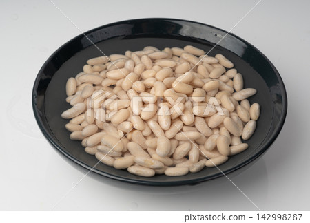 Soaked white beans, legume seeds in water Soaked white beans, legume seeds in water 142998287