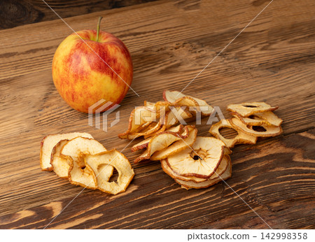 Dry apple slices pile. Dried apple chips Dry apple slices pile. Dried apple chips 142998358