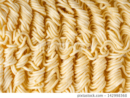 Instant noodles texture background, dry ramen noodle macro pattern Instant noodles texture background, dry ramen noodle macro pattern 142998368