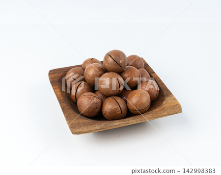 Macadamia nuts isolated. Natural raw peeled macadamia seeds and shells Macadamia nuts isolated. Natural raw peeled macadamia seeds and shells 142998383