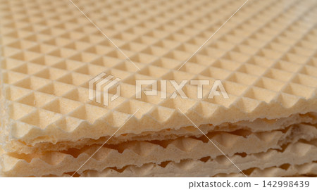 Waffle textured background, crispy wafer cake pattern Waffle textured background, crispy wafer cake pattern 142998439