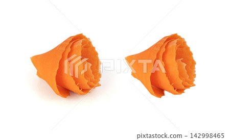 Thin carrot strips swirled in a rose flower shape isolated. Carrot slices for salad decoration Thin carrot strips swirled in a rose flower shape isolated. Carrot slices for salad decoration 142998465