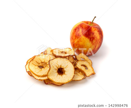 Dry apple slices isolated, dried apple chips, healthy fruit snack Dry apple slices isolated, dried apple chips, healthy fruit snack 142998476