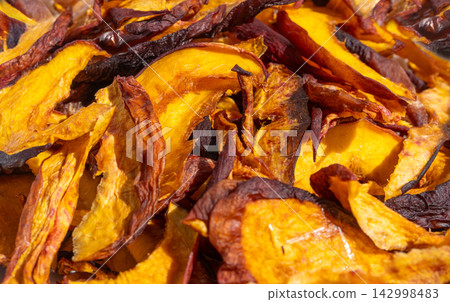 Dried nectarines and peaches in fruit dryer close up Dried nectarines and peaches in fruit dryer close up 142998483