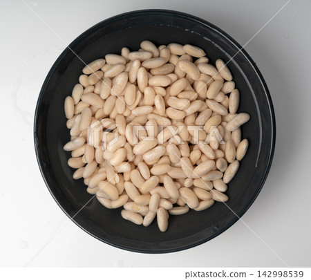 Soaked white beans, legume seeds in water Soaked white beans, legume seeds in water 142998539